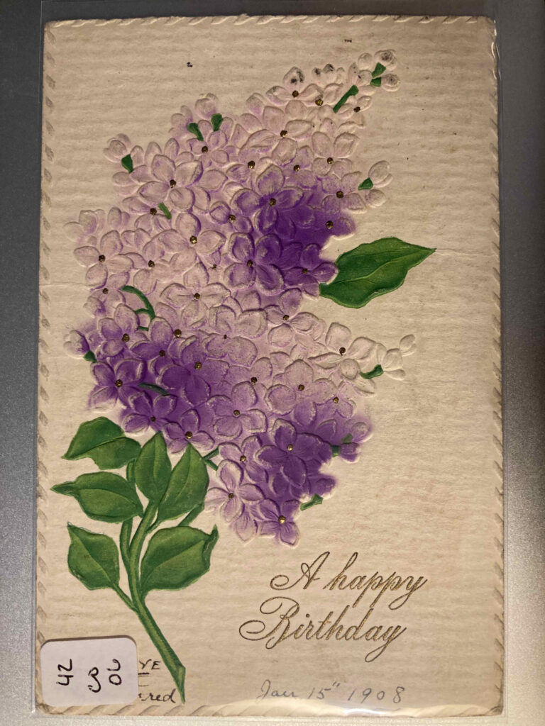 A spray of lilacs with the caption "A happy Birthday" plus manuscript additions "WITH LOVE From Fred" and "Jan. 15th '08"