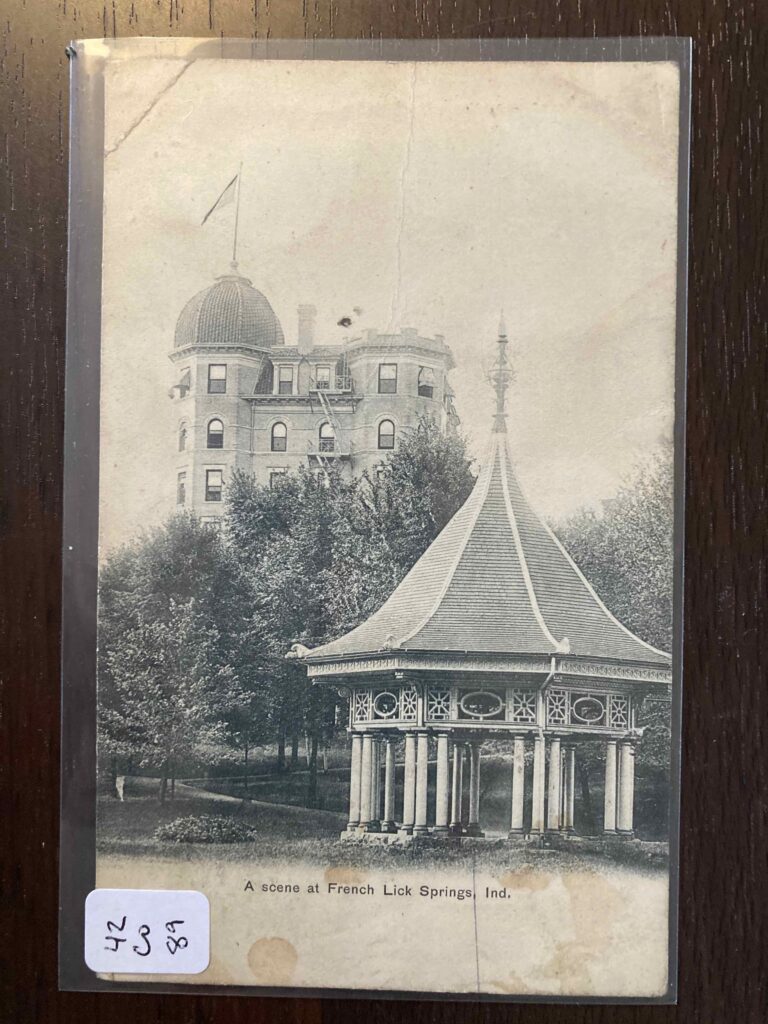 A scene at French Lick Springs, Indiana, showing a towered building topped with a dome and a gazebo.